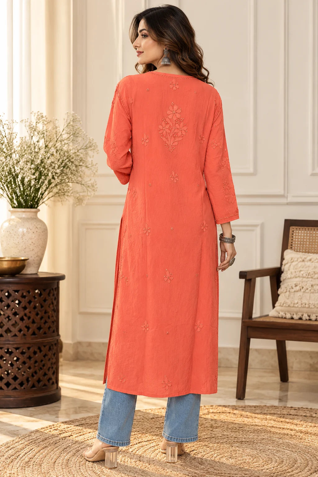 Woman wearing a lucknowi chikankari orange-colored kurta