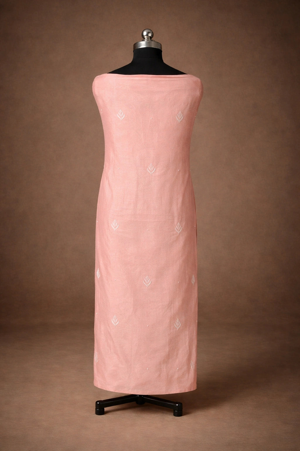 Lucknowi Chikankari Pink dress on a mannequin against a brown background