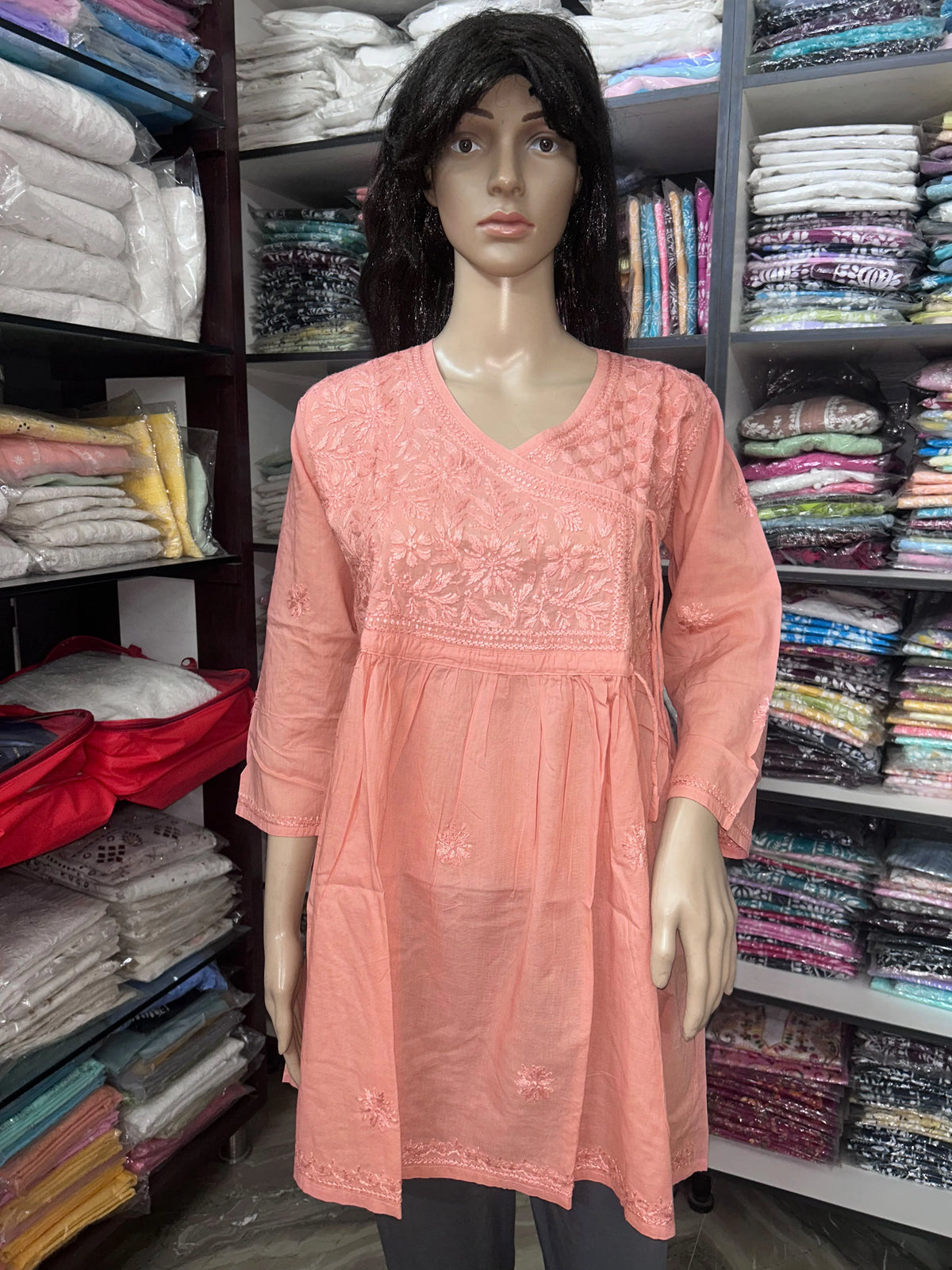 lucknowi chikankari Mannequin wearing a top in a fabric store.