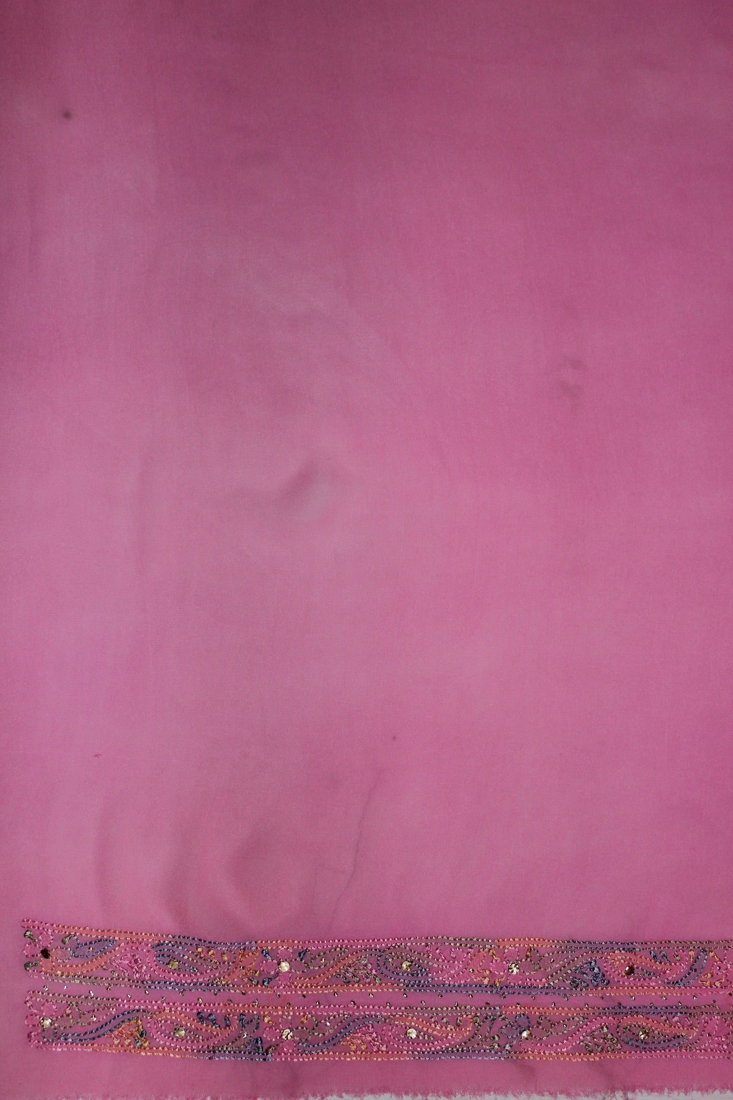 lucknowi chikankari Pink fabric with a decorative border at the bottom