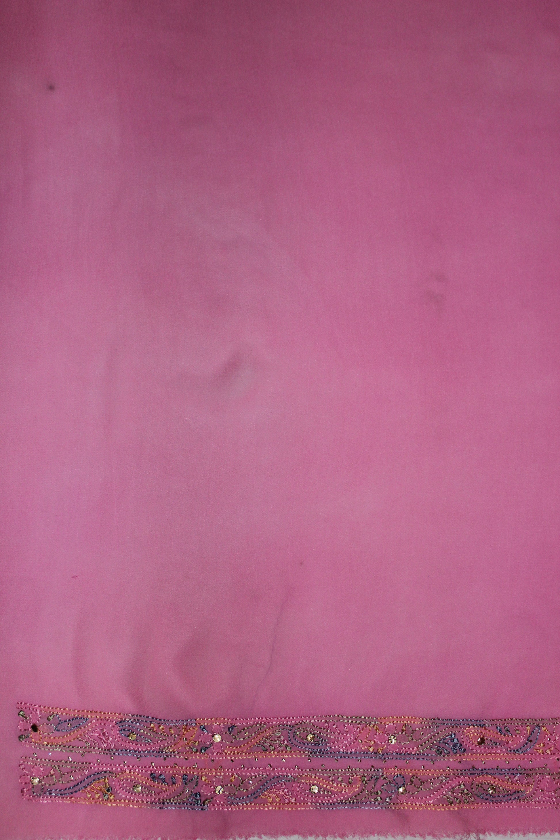 lucknowi chikankari Pink fabric with a decorative border at the bottom
