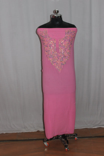 lucknowi chikankari Pink dress with intricate beading on a mannequin against a plain background