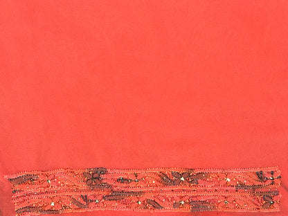 lucknowi chikankari Red fabric with decorative brown pattern on a red background