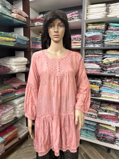 Mannequin wearing a lucknowi chikankari pink dress in a fabric store