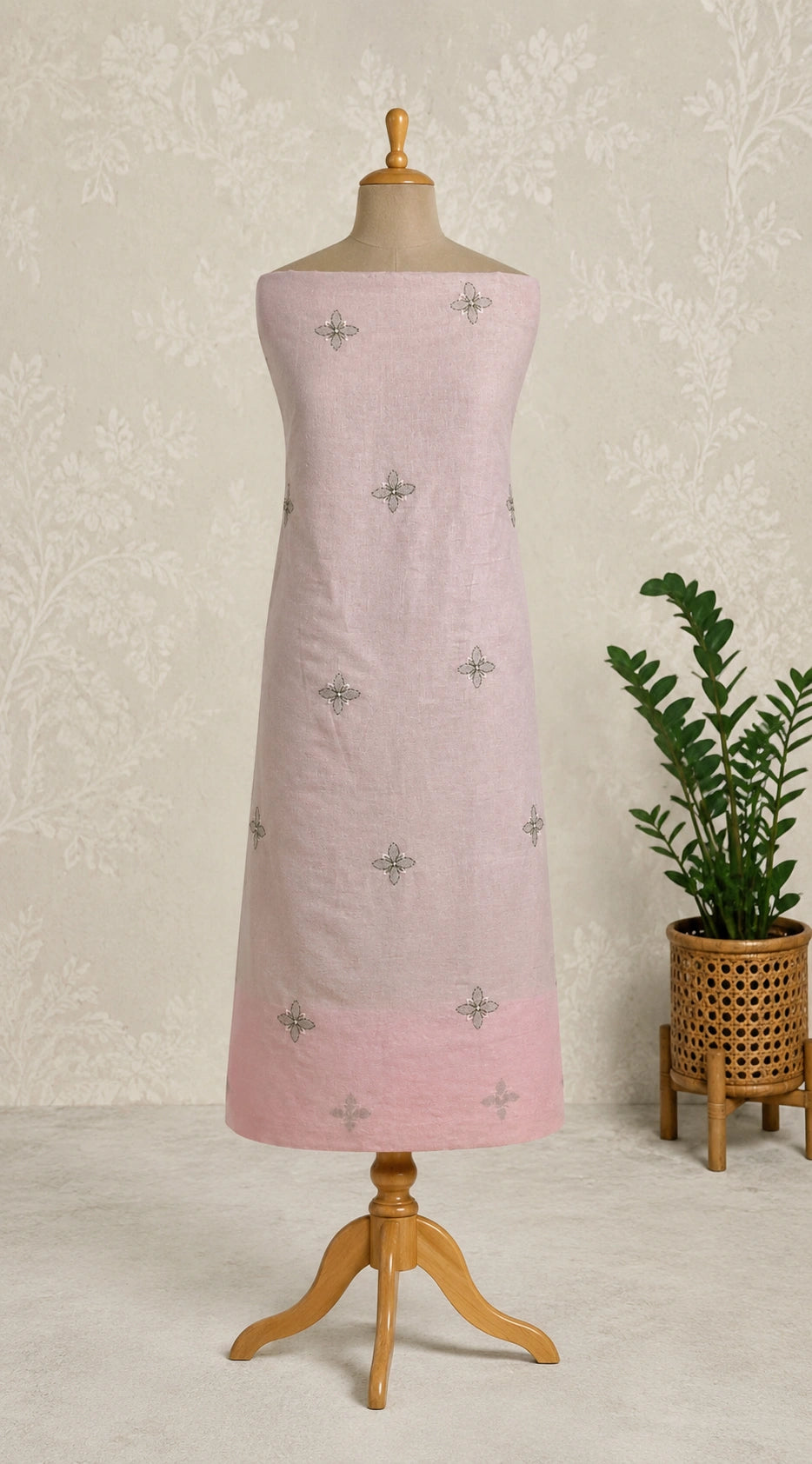 Lucknowi chikankari Pink dress on a mannequin with a plant in the background