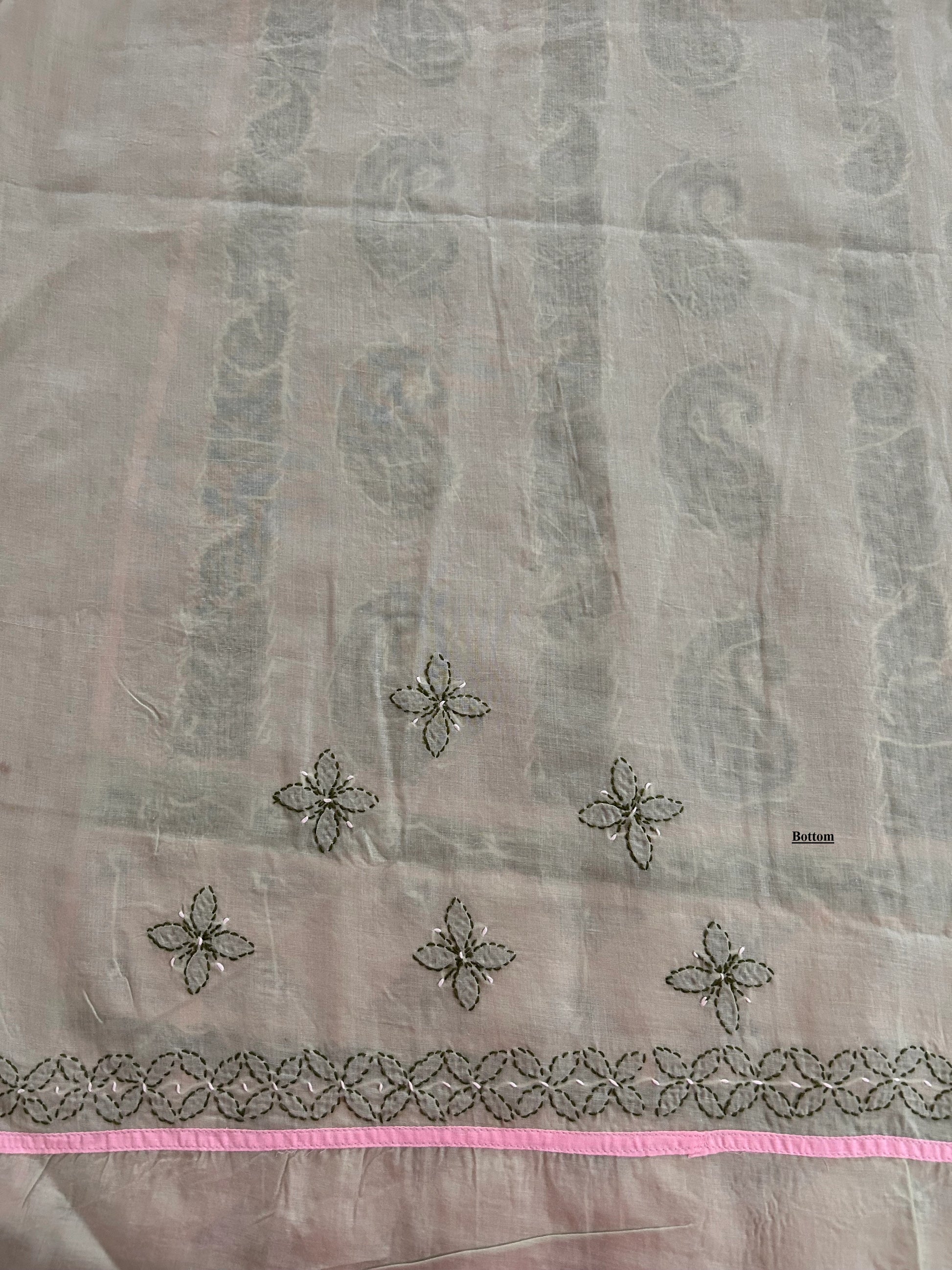 Sheer fabric with floral embroidery and pink border on a light gray background
