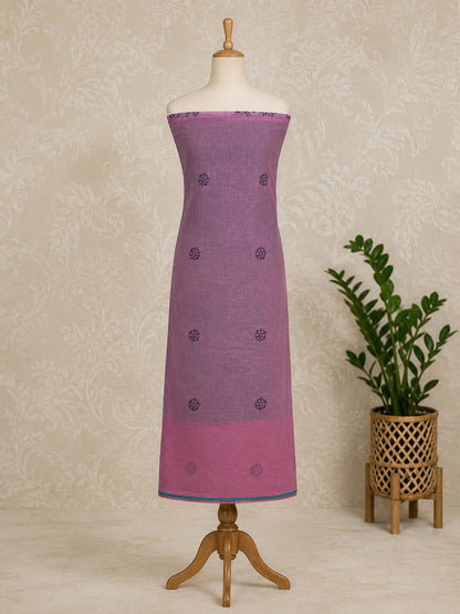 Lucknowi chikankari Purple dress on a mannequin with a plant in the background