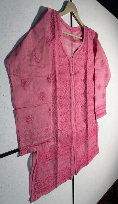 Pink embroidered shirt on a hanger against a white background