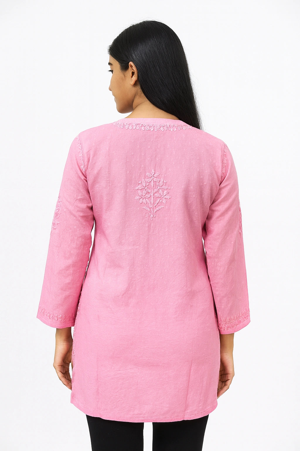 Woman wearing a pink embroidered kurta on a white background