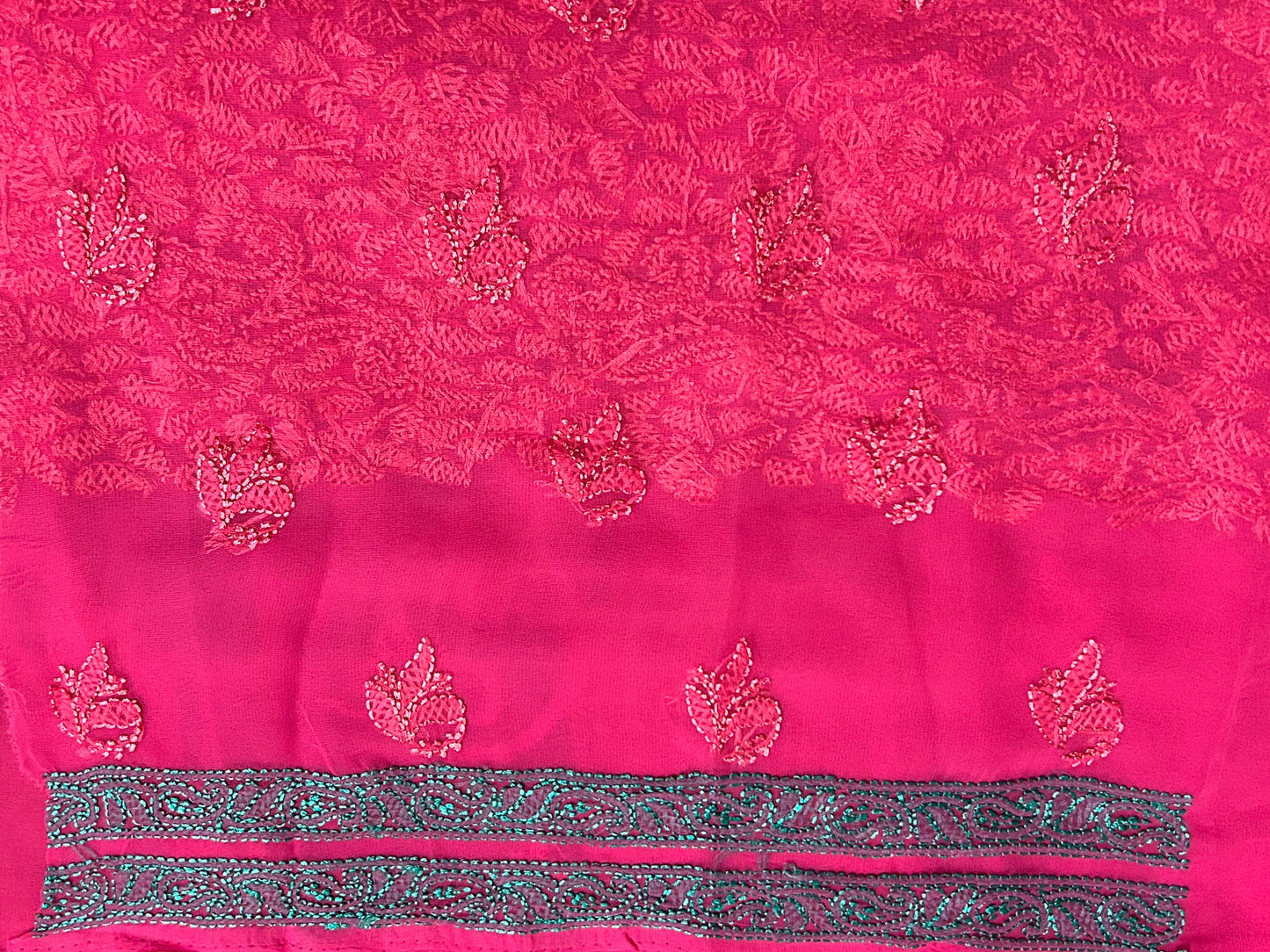 Close-up of a red floral embroidery pattern on fabric