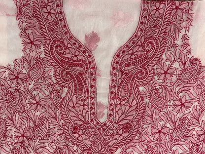 Close-up of a red floral embroidery pattern on fabric