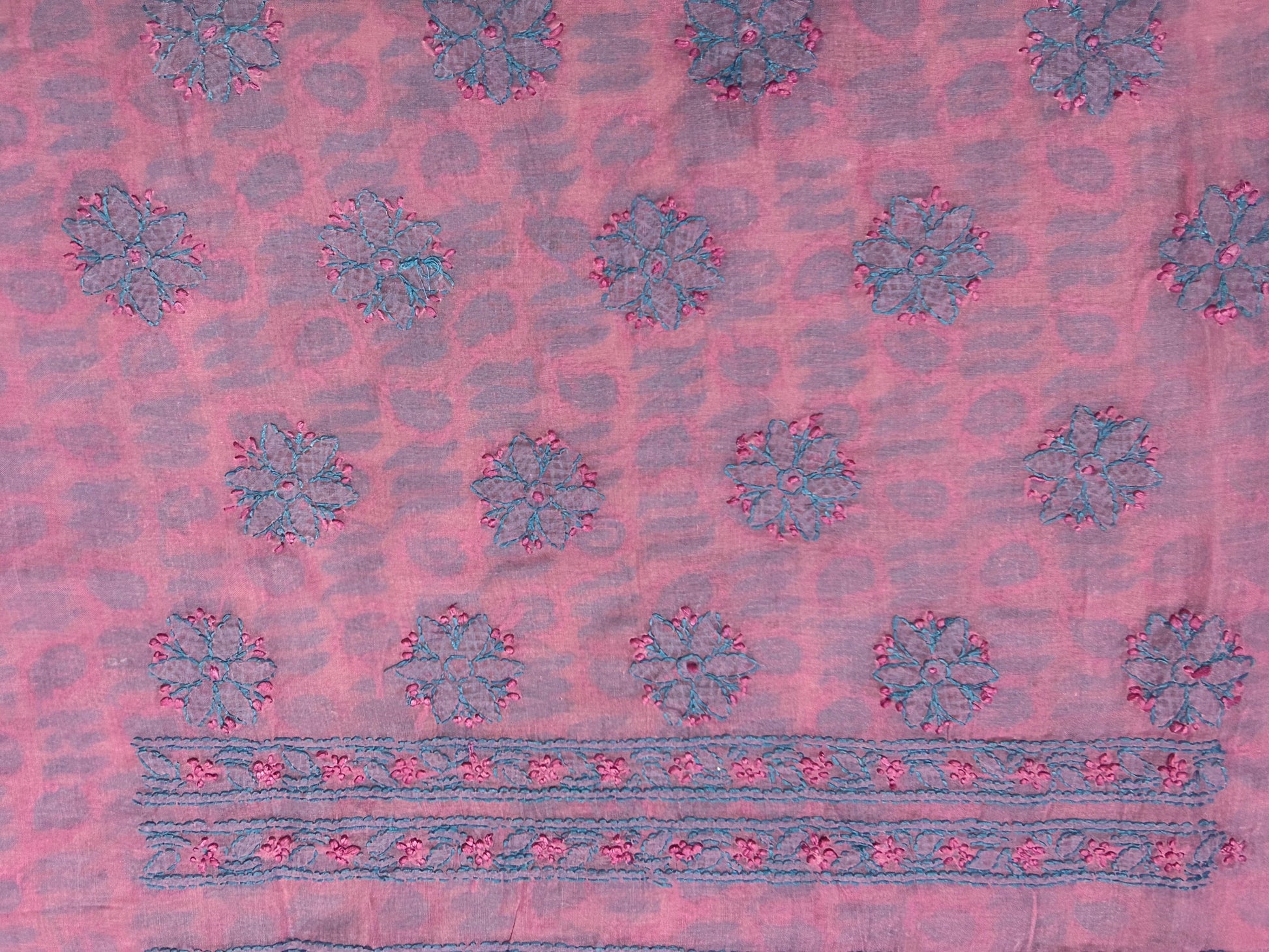 Pink fabric with blue floral patterns and border