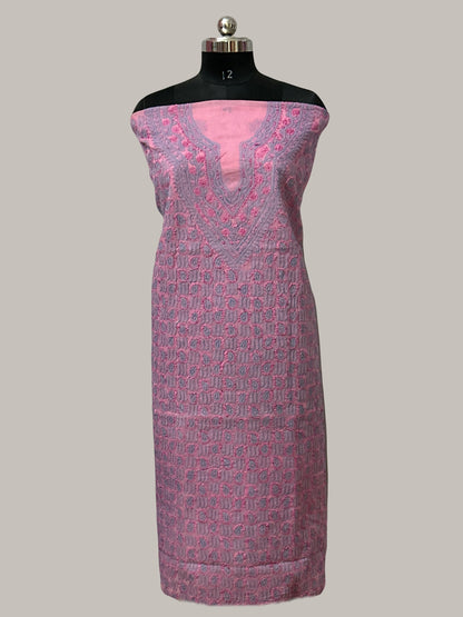 Mannequin wearing a pink and purple patterned dress on a plain background