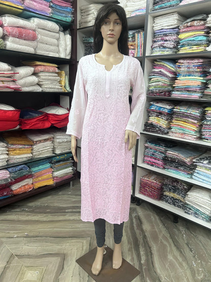 A pink embroidered long kurta displayed on a female mannequin inside a clothing store. The kurta features a split neckline, long sleeves, and delicate embroidery.