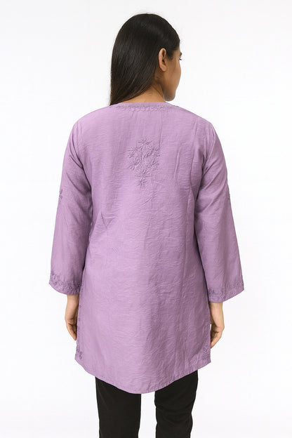 Person wearing a lucknowi chikankari purple long-sleeve top on a white background
