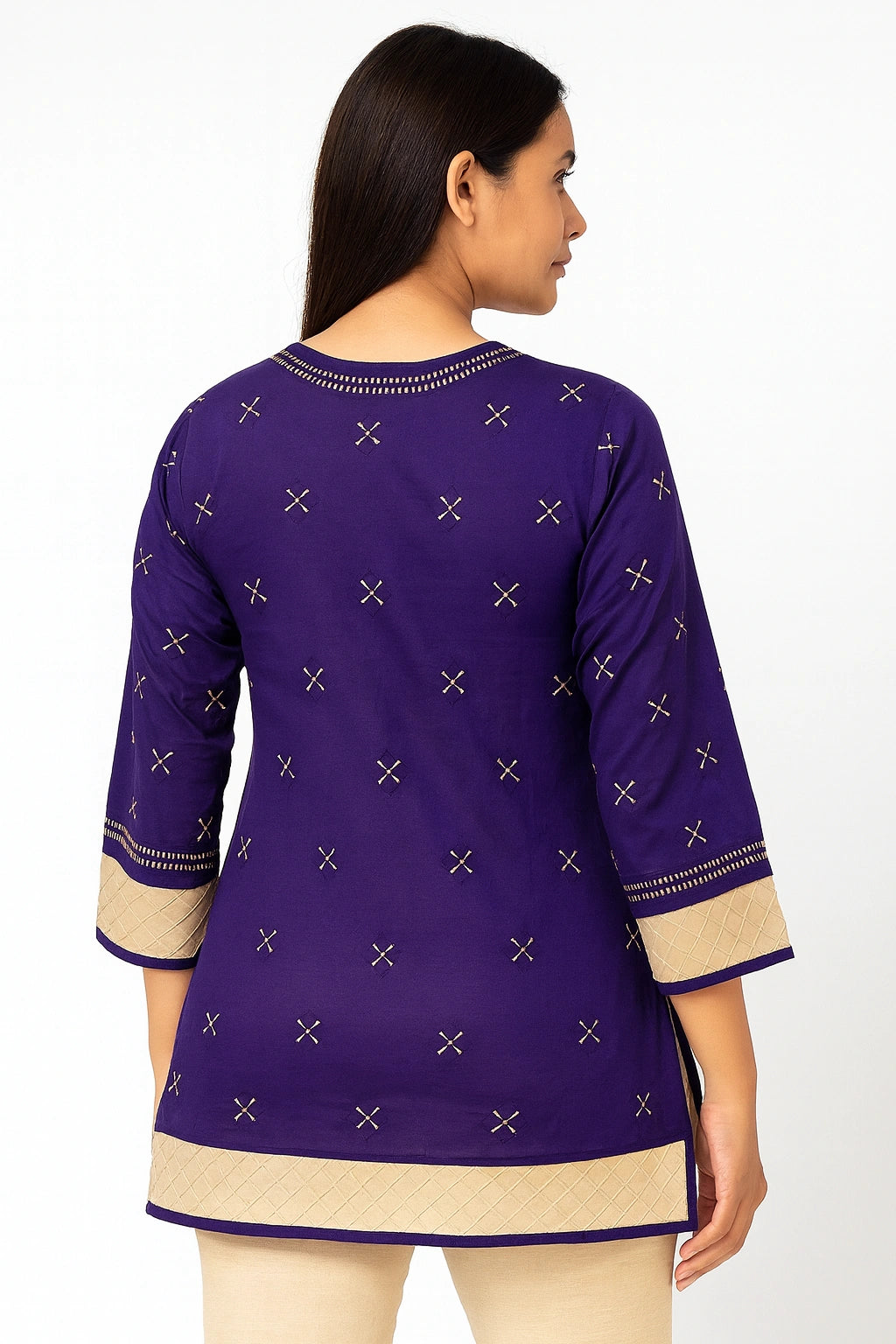 Woman wearing a lucknowi chikankari purple and beige traditional outfit with intricate patterns on a white background