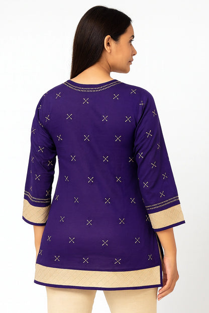 Woman wearing a lucknowi chikankari purple and beige traditional outfit with intricate patterns on a white background