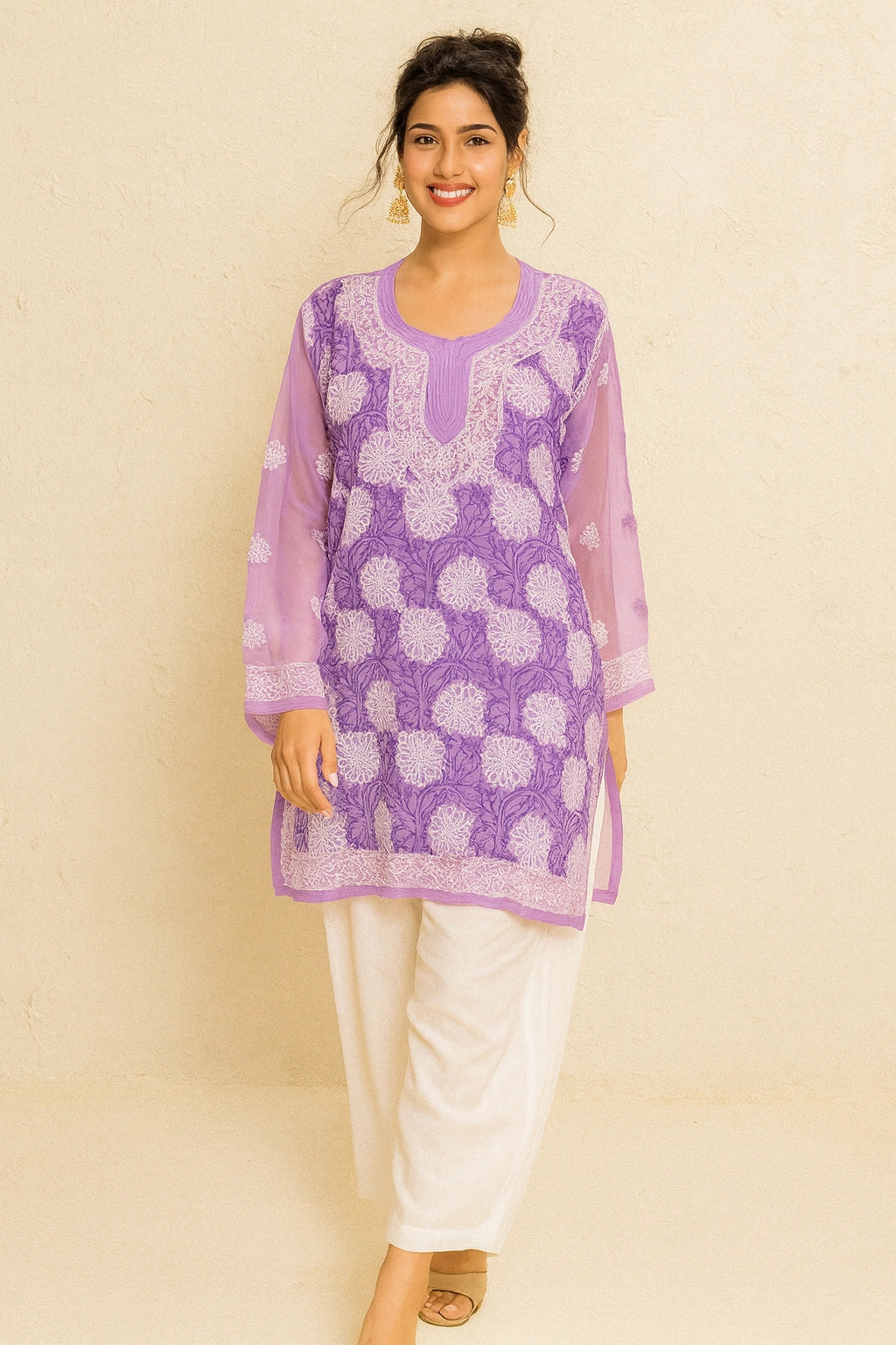 Woman wearing a purple embroidered kurta with white pants on a beige background