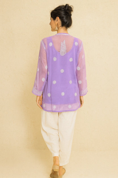 lucknowi chikankari Woman wearing a purple polka dot top with a beige background