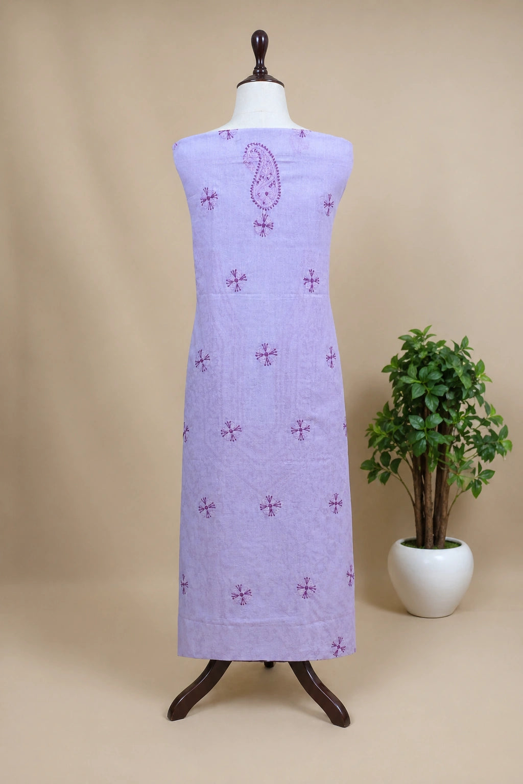 lucknowi chikankari Purple dress with pattern on a mannequin against a beige background