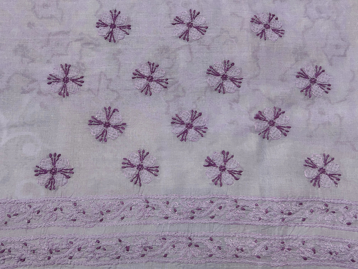 lucknowi chikankari Textile with purple floral patterns on a light gray background