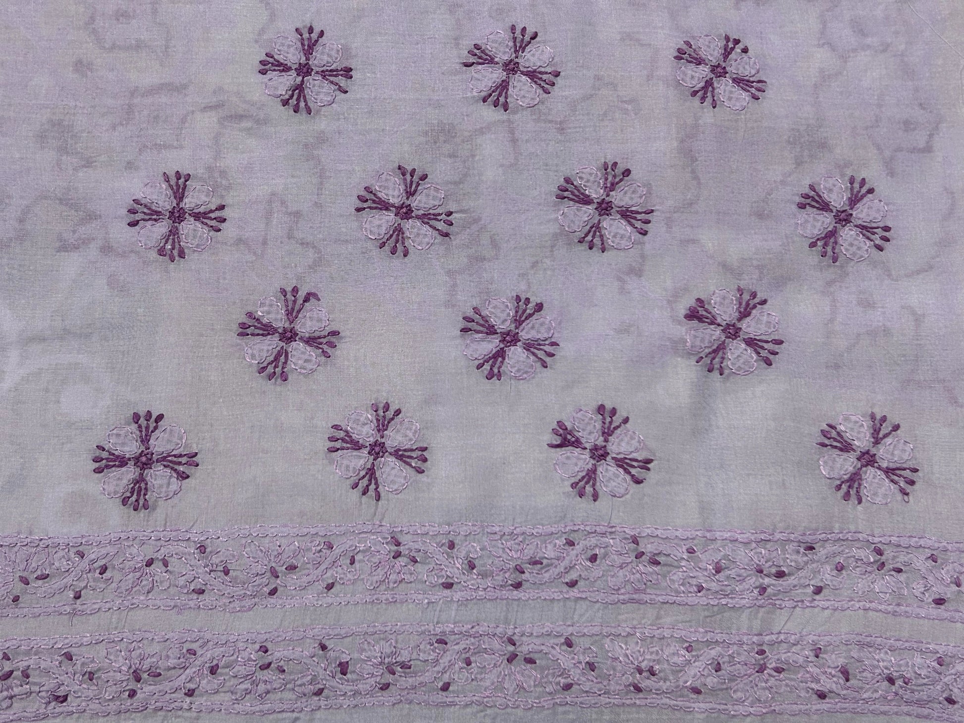 lucknowi chikankari Textile with purple floral patterns on a light gray background