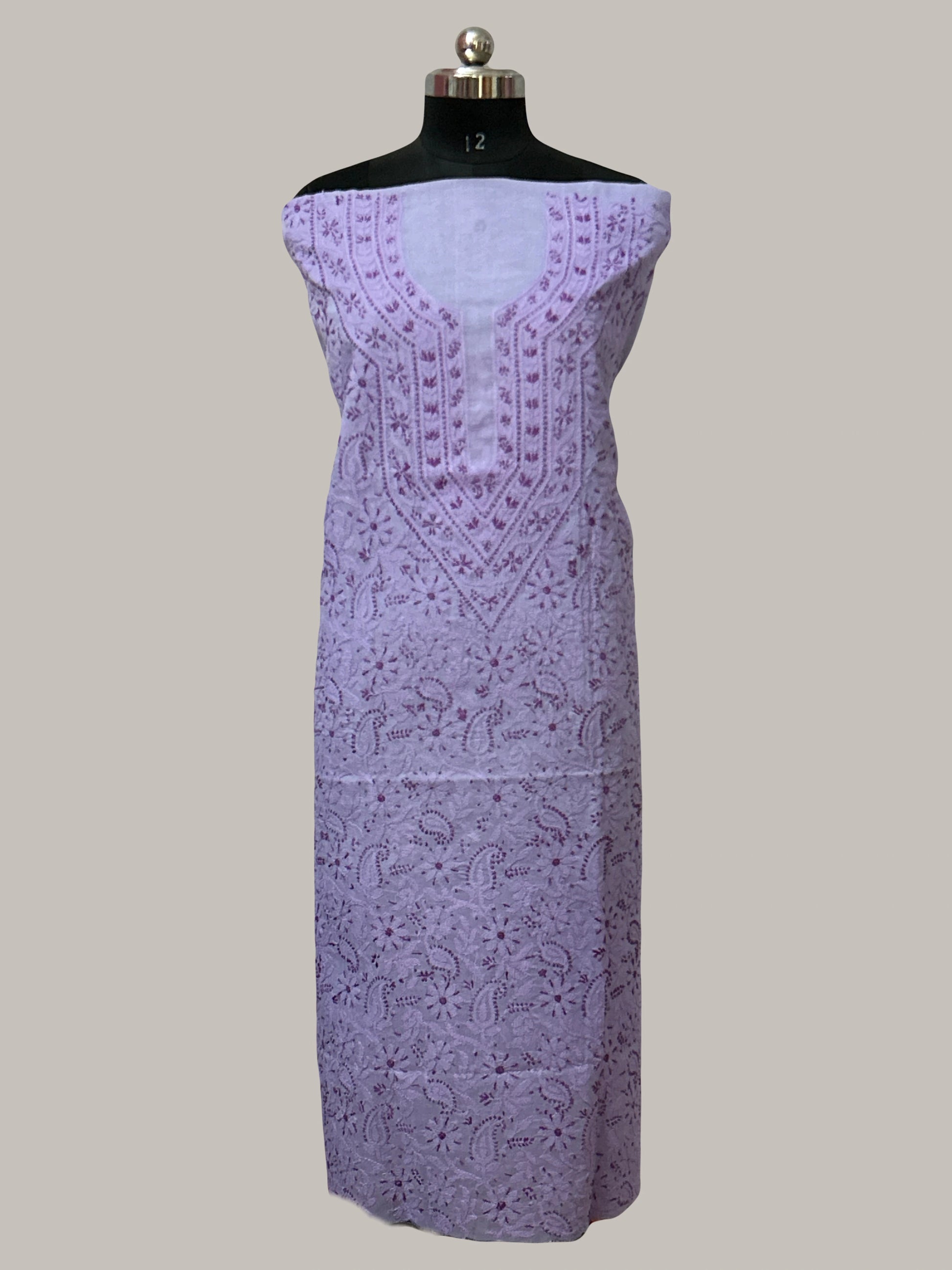 Lucknowi chikankari Lavender dress with intricate patterns on a mannequin against a plain background