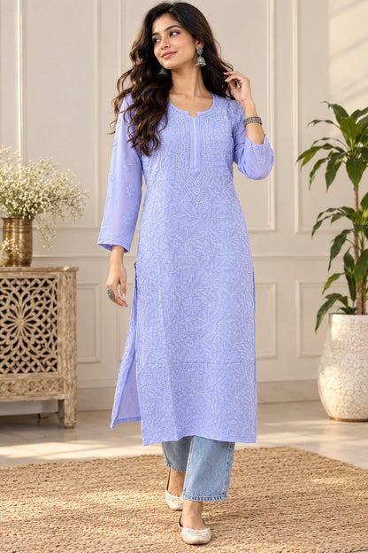 Woman wearing a lucknowi chikankari purple-colored kurta with white floral patterns 
