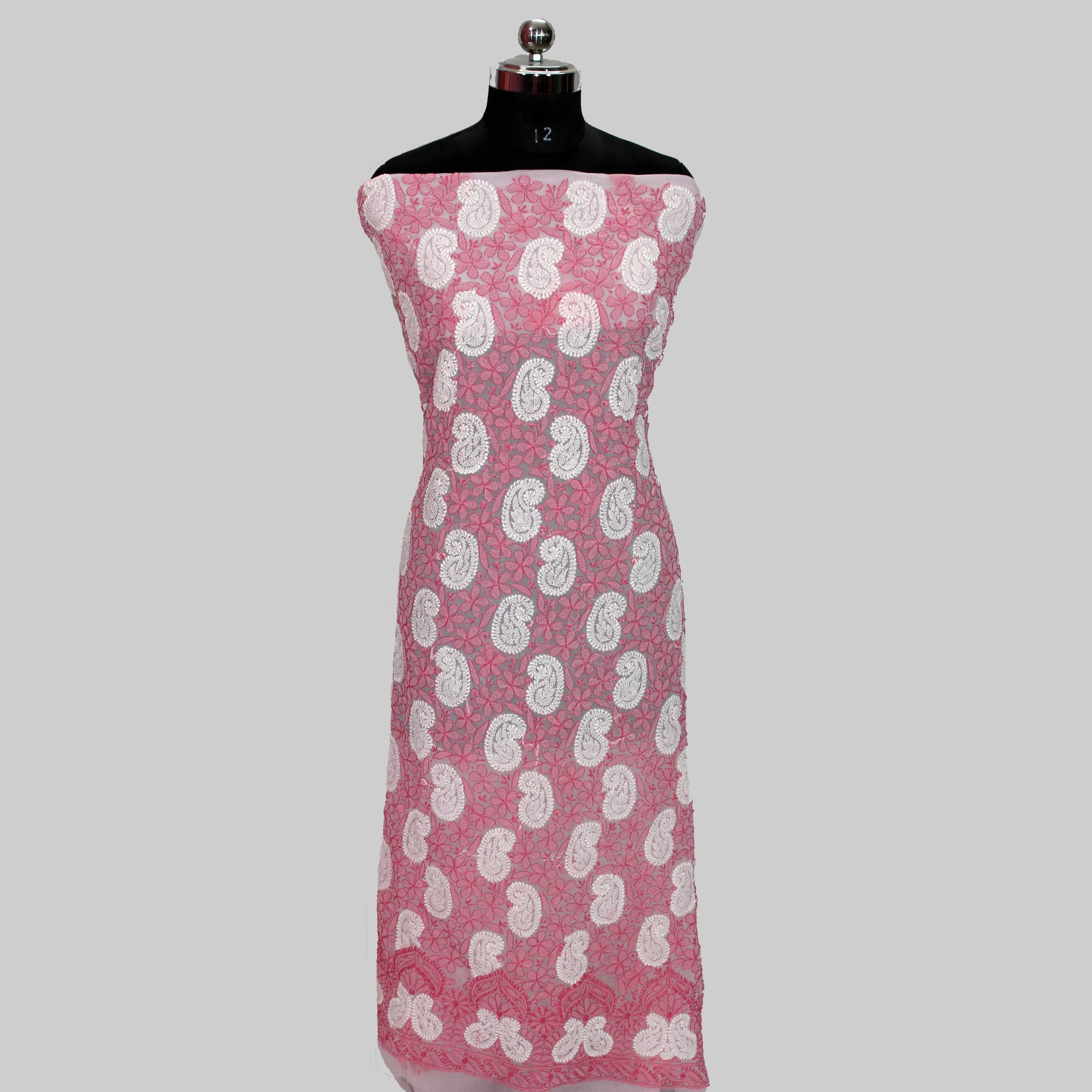 Mannequin wearing a lucknowi chikankari pink dress with white floral patterns on a gray background