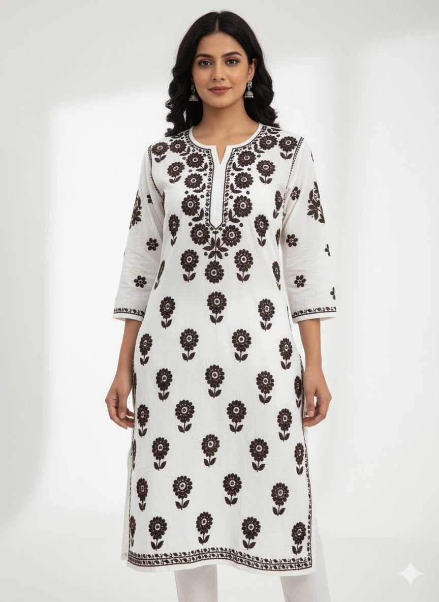 Woman wearing a lucknowi chikankari white kurta with black floral patterns on a white background