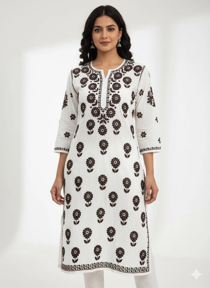 Woman wearing a lucknowi chikankari white kurta with black floral patterns on a white background