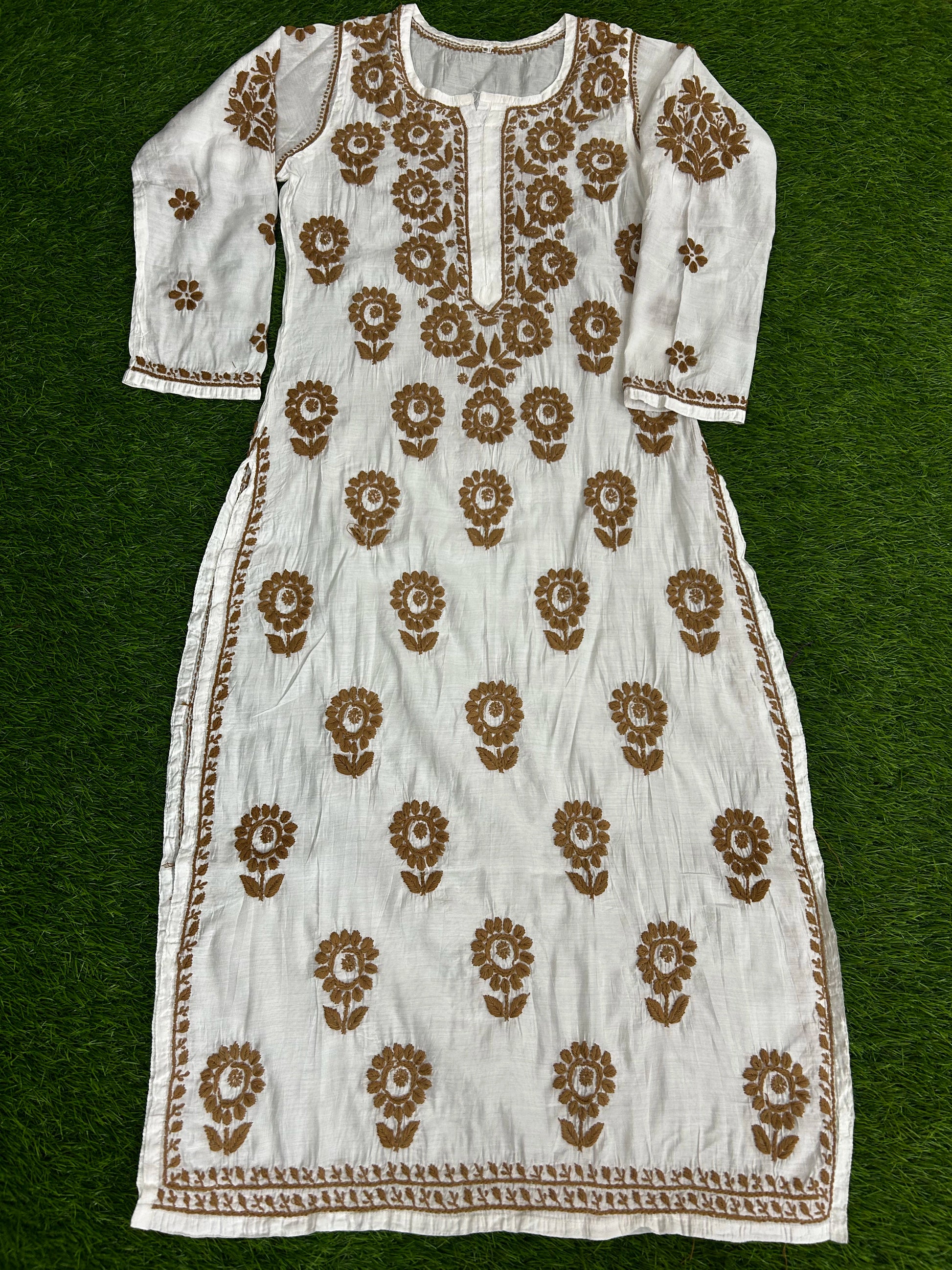 Lucknowi chikankari White dress with brown floral patterns on a green background