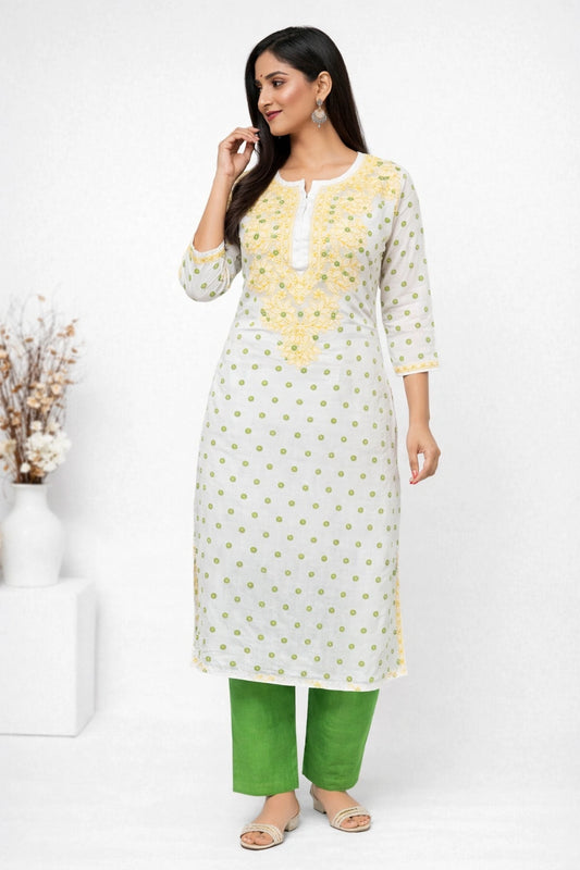 Woman wearing a white and yellow kurta with green pants on a white background
