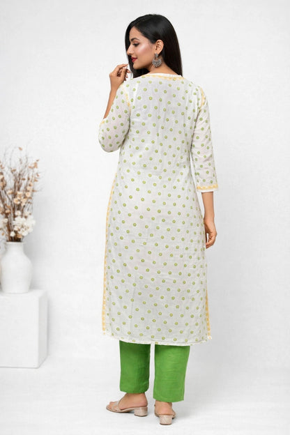 Woman wearing a white kurta with green pants on a white background