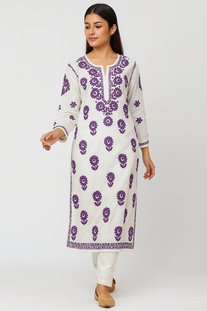 Woman wearing a lucknowi chikankari white kurta with purple floral patterns on a white background