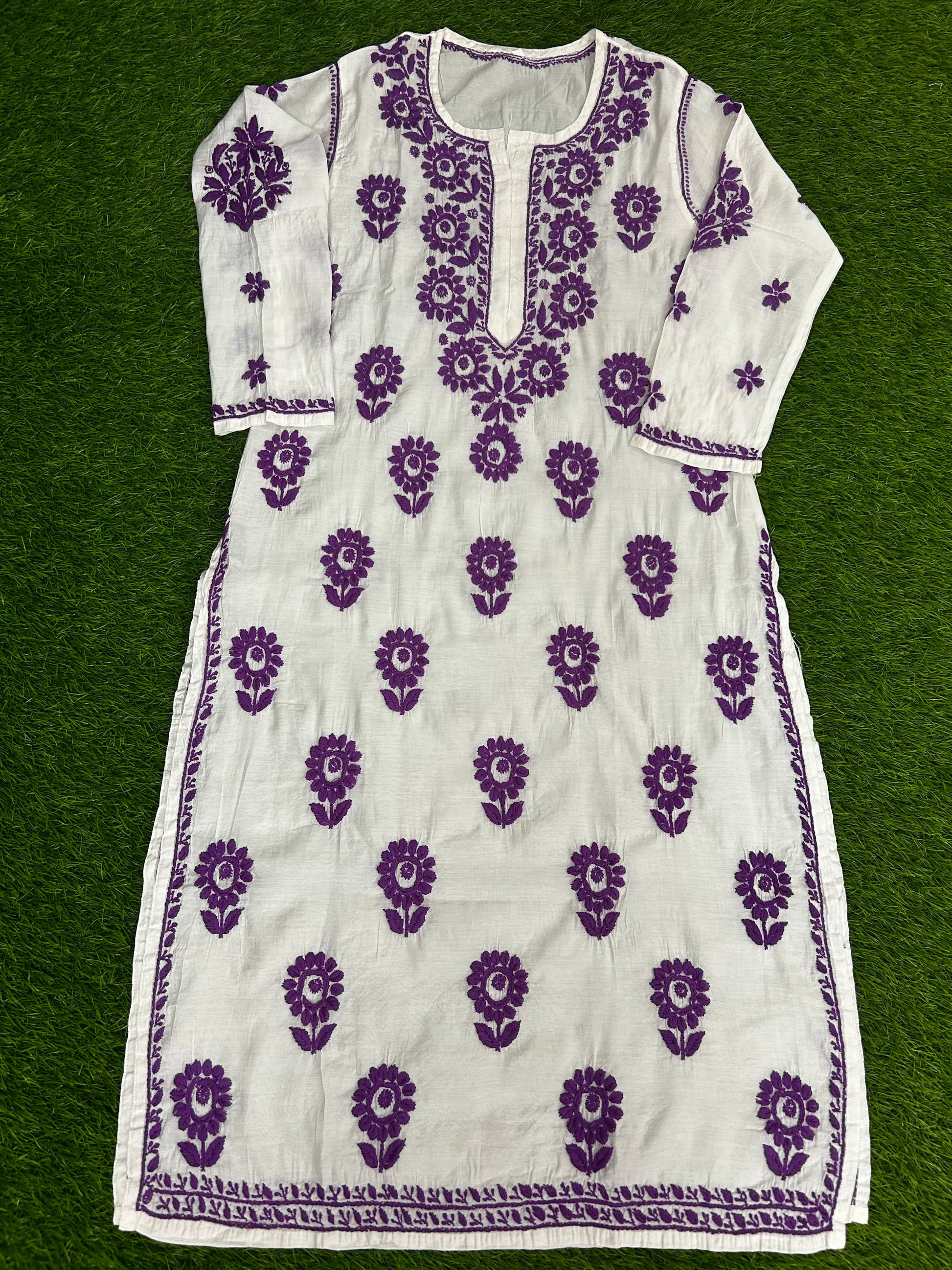 lucknowi chikankari White dress with purple floral patterns on a green background