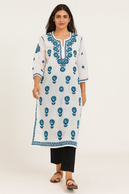 Woman wearing a lucknowi chikankari white kurta with blue floral patterns on a white background