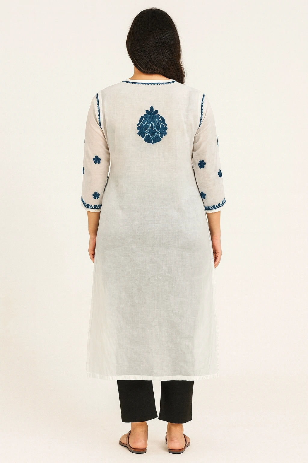 Woman wearing a lucknowi chikankari  white kurta with blue floral embroidery on a white background