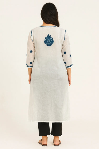 Woman wearing a lucknowi chikankari  white kurta with blue floral embroidery on a white background