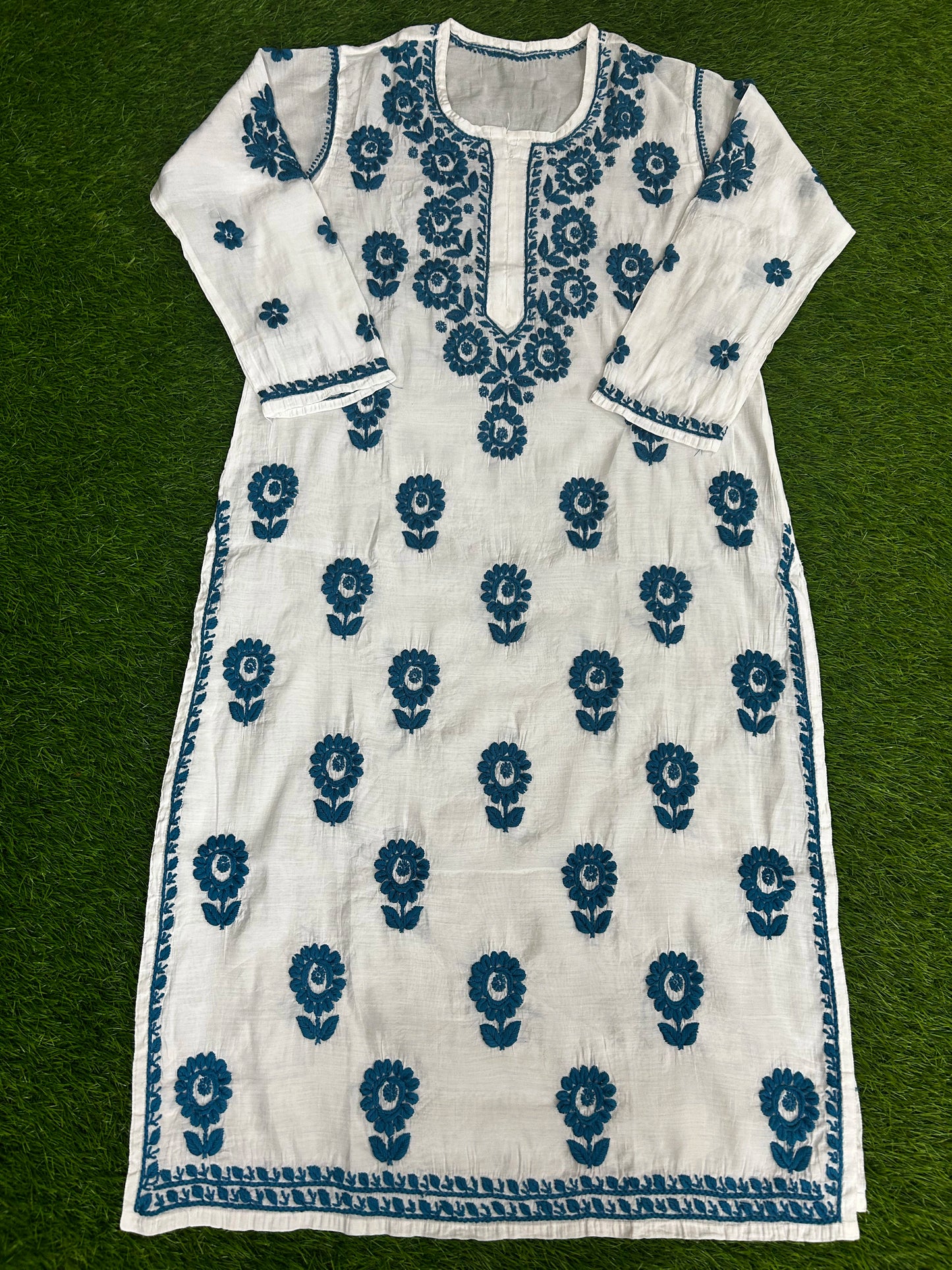 lucknowi chikankari White dress with blue floral patterns on a green background