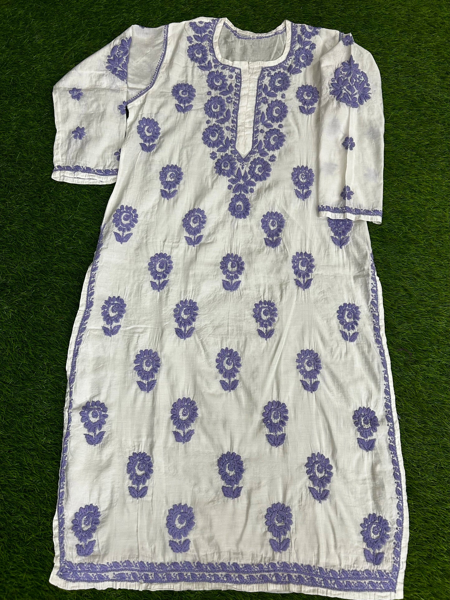 lucknowi chikankari White dress with purple floral patterns on a green background