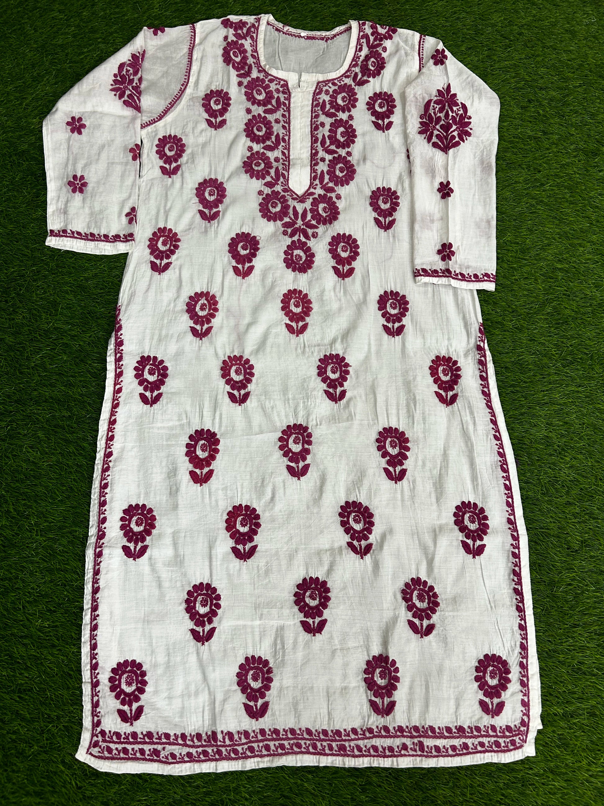 lucknowi chikankari White dress with red floral patterns on a green background