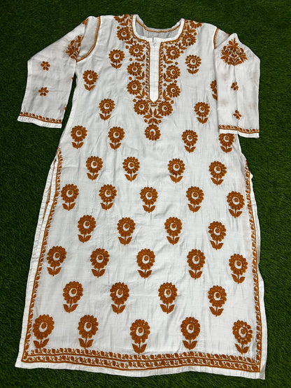 lucknowi chikankari White kurta with brown floral patterns on a green background