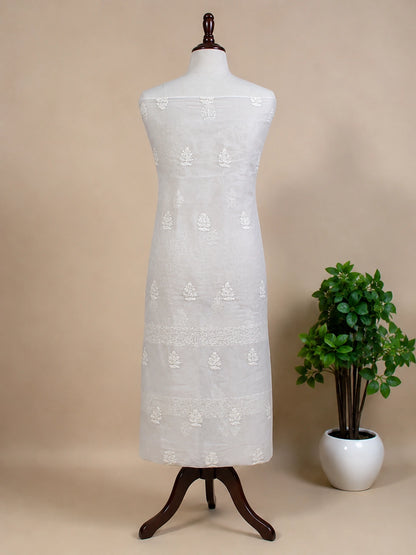 Lucknowi chikankari White lace dress on a mannequin with a plant on a beige background