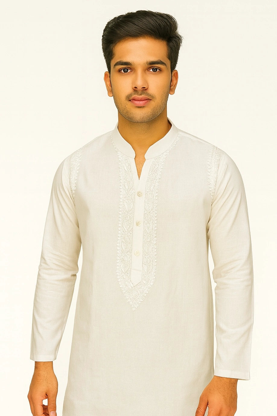 Man wearing a lucknowi chikankari white kurta against a plain background
