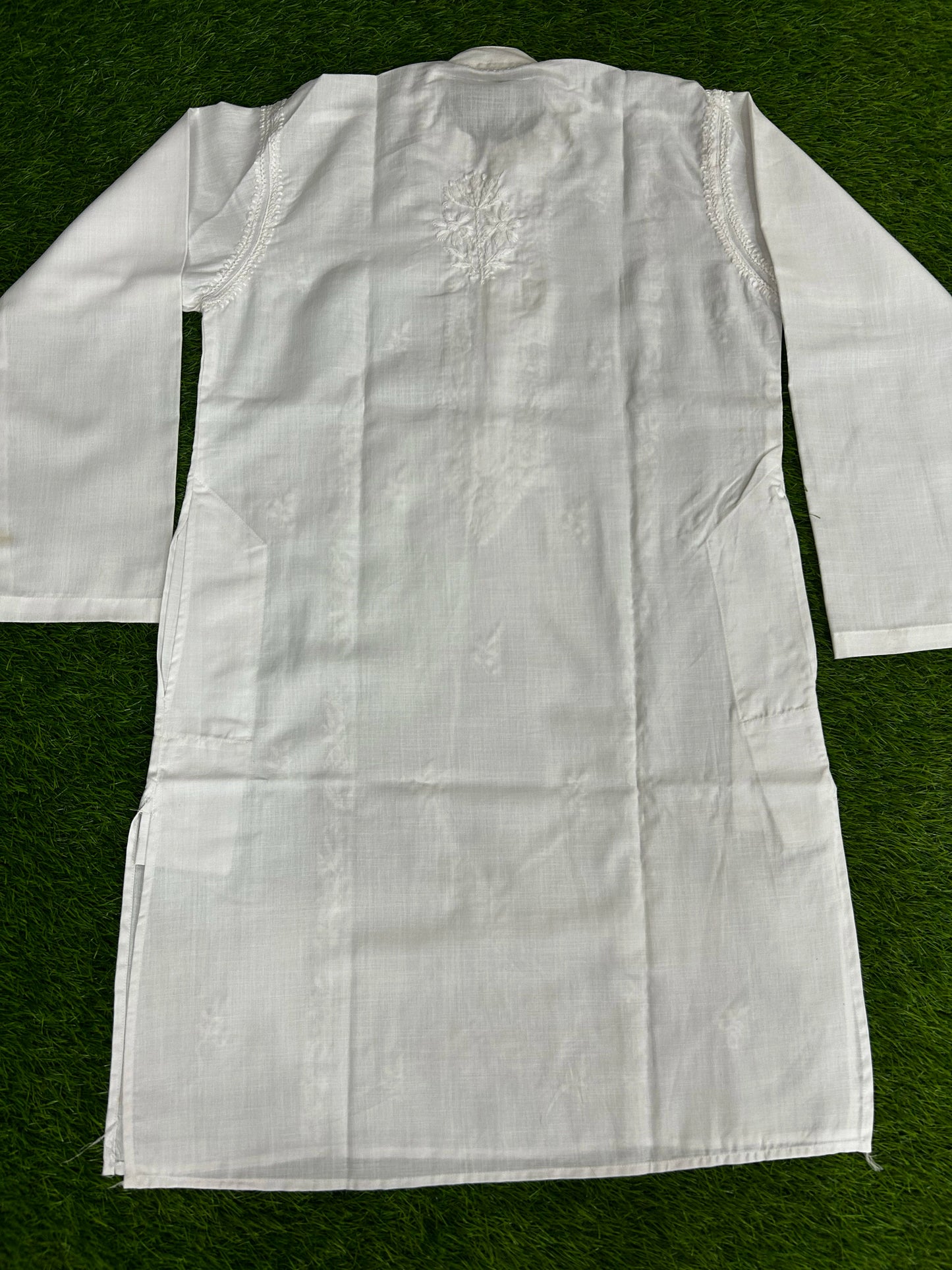 White lab coat with embroidery on a green background