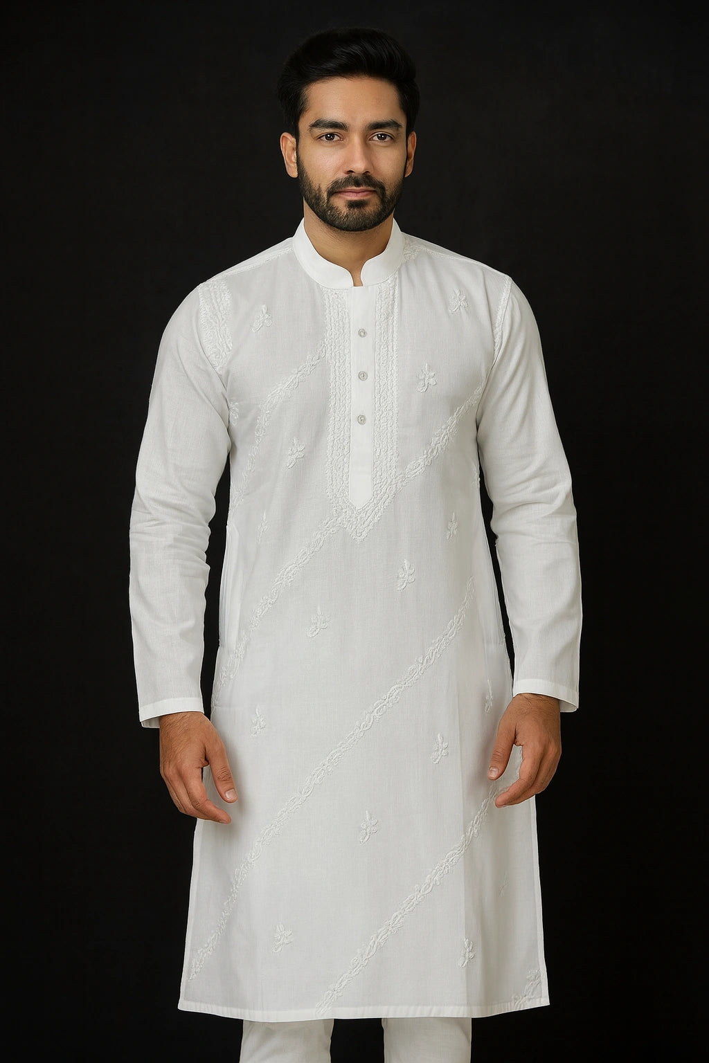 Man wearing a lucknowi chikankari white kurta with intricate patterns on a black background