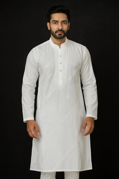 Man wearing a lucknowi chikankari white kurta with intricate patterns on a black background