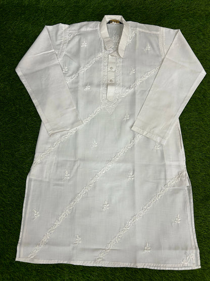 White embroidered kurta on a green background