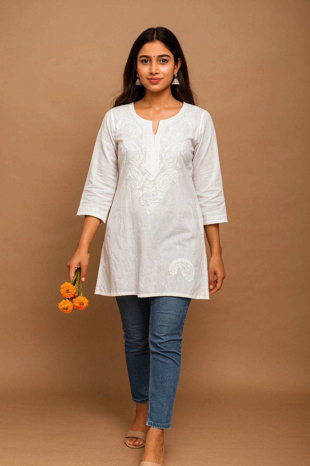 lucknowi chikankari Woman wearing a white kurta with blue jeans against a brown background